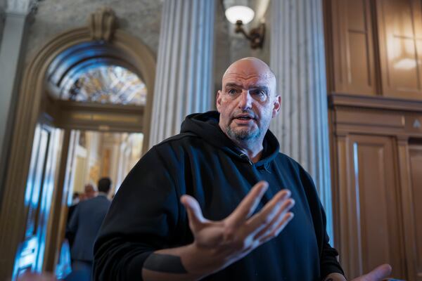 FILE - Sen. John Fetterman, D-Pa., talks to reporters outside the chamber during a vote at the Capitol in Washington, March 13, 2025. (AP Photo/J. Scott Applewhite, File)