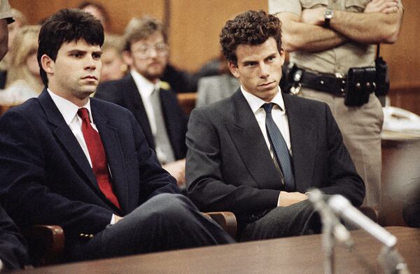 FILE - Lyle, left, and Erik Menendez sit in Beverly Hills Municipal Court where their attorneys delayed making pleas on behalf of the brothers who are suspected in the murders of their parents on March 12, 1990. (AP Photo/Nick Ut)