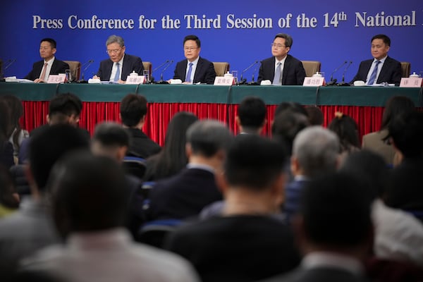 Key Chinese finance and economy officials from left, Wu Qing, Chairman of the China Securities Regulatory Commission, Wang Wentao, Commerce Minister Zheng Shanjie, Chairman of the National Development and Reform Commission, Lan Fo'an, Finance Minister, Pan Gongsheng, Governor of the People's Bank of China, meet the press on the sideline of the National People's Congress in Beijing, China, Thursday, March 6, 2025. (AP Photo/Vincent Thian)