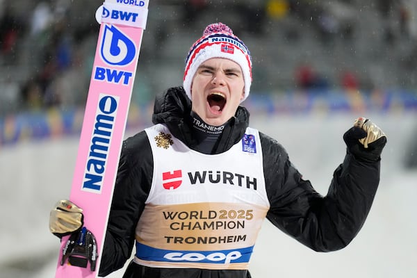 Marius Lindvik, of Norway, celebrates after winning the gold medal in the ski jumping men's normal hill HS102 event at the Nordic World Ski Championships in Trondheim, Norway, Sunday, March 2, 2025. (AP Photo/Matthias Schrader)