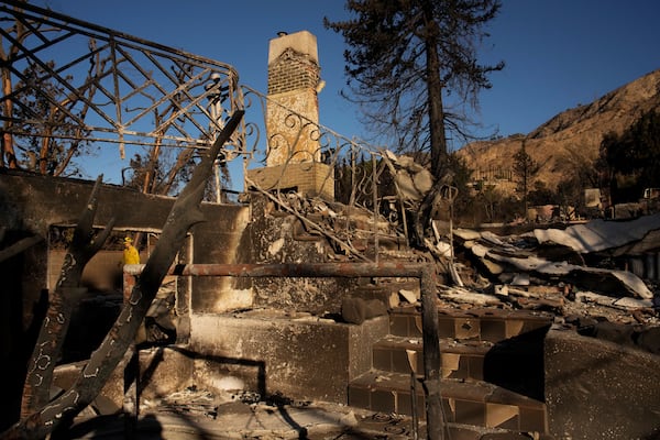 A firefighter inspects homes destroyed by the Eaton Fire in in Altadena, Calif., is seen Wednesday, Jan 15, 2025. (AP Photo/John Locher)