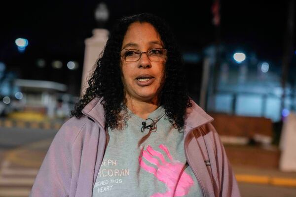 Calling herself his wife, Tahina Corcoran speaks outside of Indiana State Prison where, barring last-minute court action or intervention by Gov. Eric Holcomb, Joseph Corcoran, 49, convicted in the 1997 killings of his brother and three other people, is scheduled to be put to death by lethal injection before sunrise Tuesday, Dec. 17, 2024, in Michigan City, Ind. (AP Photo/Erin Hooley)