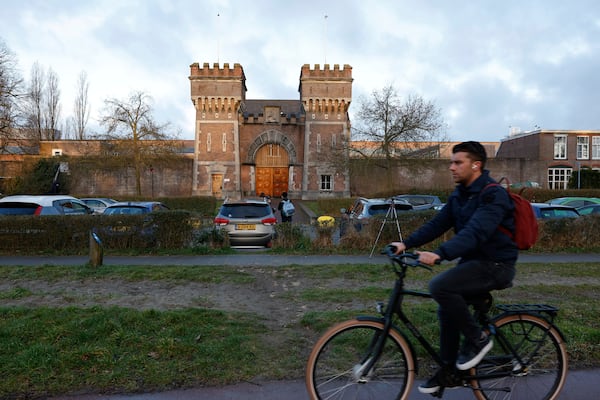 A cyclist drives past one of the entrances to the International Criminal Court detention center near The Hague in Scheveningen, Netherlands, Wednesday, March 12, 2025. (AP Photo/Omar Havana)