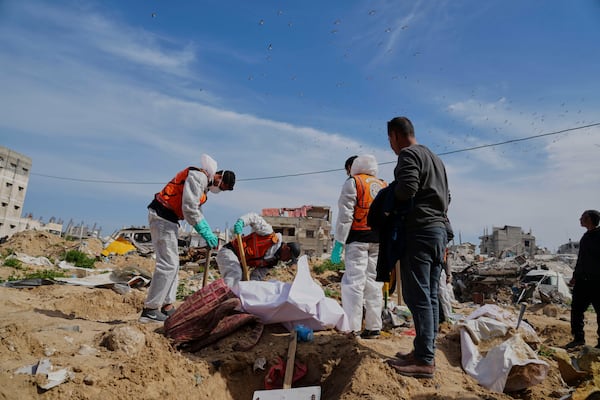 The bodies of Palestinians killed during the Israel-Hamas war and were buried in a mass grave at Shifa Hospital yard are exhumed for identification and reburial in Gaza City's official cemeteries, on Thursday, March 13, 2025. (AP Photo/Abdel Kareem Hana)