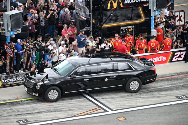 President Donald Trump rides in the presidential limousine known as "The Beast" down pit lane ahead of the start of the NASCAR Daytona 500 auto race at Daytona International Speedway, Sunday, Feb. 16, 2025, in Daytona Beach, Fla. (AP Photo/Phelan M. Ebenhack)