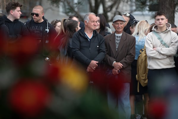 People wait in line to write condolence messages for the victims of a massive nightclub fire in the town of Kocani, North Macedonia, Monday, March 17, 2025. (AP Photo/Boris Grdanoski)