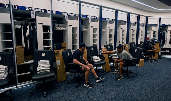 New York Yankees clubhouse attendants wait near the players' lockers during a tour of the upgraded team spring training facilities Thursday, Feb. 13, 2025, at George M. Steinbrenner Field in Tampa, Fla. (AP Photo/Steve Nesius)