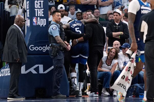 Minnesota Timberwolves guard Anthony Edwards (5) leaves the court after sustaining an injury during the first half of Game 2 of an NBA basketball second-round playoff series against the Golden State Warriors, Thursday, May 8, 2025, in Minneapolis. (AP Photo/Abbie Parr)