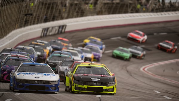 Austin Cindric (2) moves on the track with Todd Gilliland, left, during a NASCAR Cup Series auto race, Sunday, Feb. 23, 2025, in Hampton, Ga. (AP Photo/Mike Stewart)