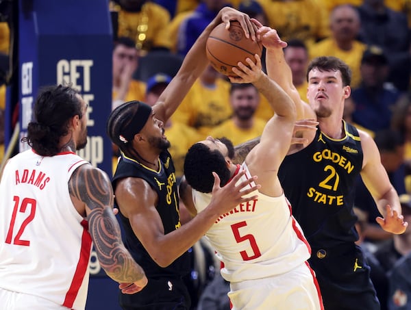 Golden State Warriors' Moses Moody, second from left, and Quinten Post, right, defend against Houston Rockets' Fred VanVleet (5) in the second quarter of Game 6 of an NBA basketball first-round playoff series Friday, May 2, 2025, in San Francisco. A foul was called on the Warriors on the play. (Scott Strazzante/San Francisco Chronicle via AP)