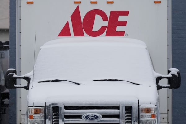 Snow covered a delivery truck in a parking lot of a hardware store during a snowy day in Glenview, Ill., Friday, Jan. 10, 2025. (AP Photo/Nam Y. Huh)