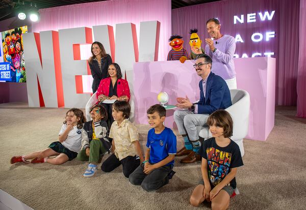 Children pose for photos with Sesame Street's Bert and Ernie and others during the Elevate Prize Foundation's Catalyst Award, Wednesday, May 14, 2025, in Miami Beach, Fla. (AP Photo/Michael Laughlin)