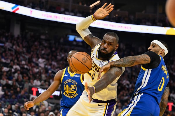 Los Angeles Lakers forward LeBron James (23) gets fouled by Golden State Warriors guard Gary Payton II (0) during the first half of an NBA basketball game Wednesday, Dec. 25, 2024, in San Francisco. (AP Photo/Eakin Howard)