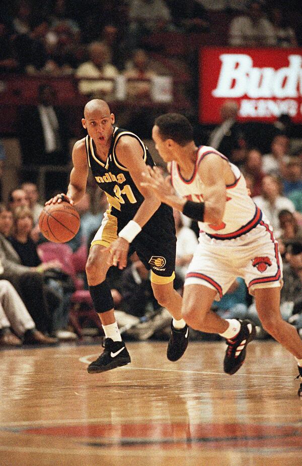 FILE - Indiana Pacers guard Reggie Miller, left, brings the ball down court while covered by New York Knicks guard John Starks during the first half of their NBA Eastern Conference Semifinals playoff game at New York's Madison Square Garden Sunday, May 7, 1995. (AP Photo/L.M. Otero, File)