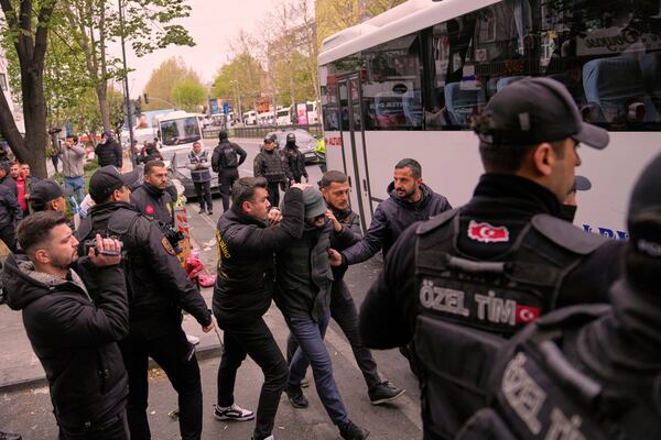 A union member is detained by Turkish police officers as he marches with others during Labor Day celebrations in Istanbul, Turkey, Thursday, May 1, 2025. (AP Photo/Khalil Hamra)