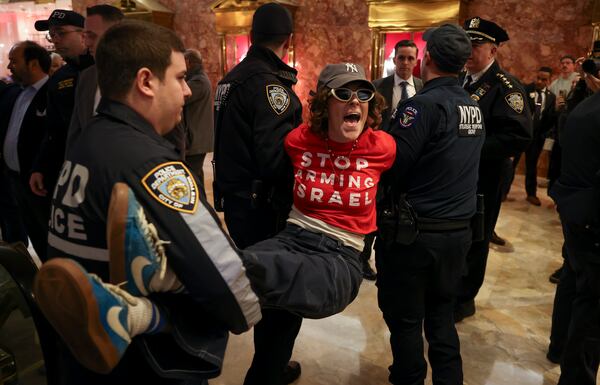 New York Police officers arrest a demonstrator from the group, Jewish Voice for Peace, who protested inside Trump Tower in support of Columbia graduate student Mahmoud Khalil, Thursday, March 13, 2025, in New York. (AP Photo/Yuki Iwamura)