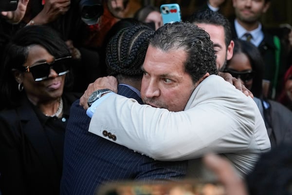 A$AP Rocky, center left, hugs attorney Joe Tacopina after he was found not guilty in his trial Tuesday, Feb. 18, 2025, in Los Angeles. (AP Photo/Damian Dovarganes)