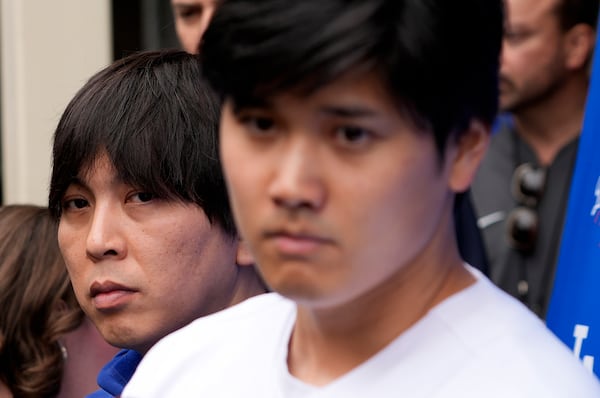 FILE - Interpreter Ippei Mizuhara, left, stands next to Los Angeles Dodgers player Shohei Ohtani, right, during an interview at Dodger Stadium, Feb. 3, 2024. (AP Photo/Richard Vogel, File)