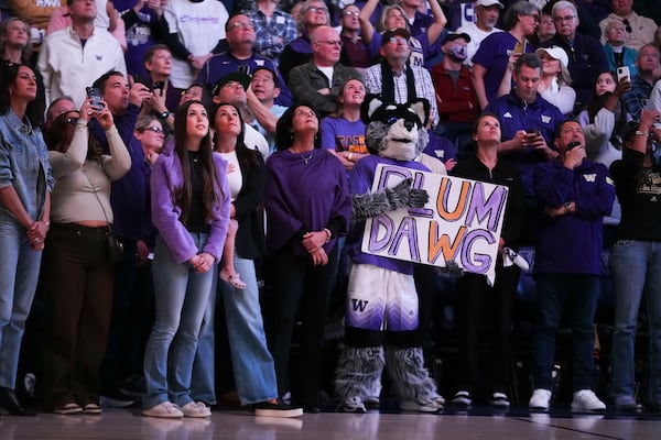 Washington mascot Harry the Husky holds a sign for former Washington guard and current Las Vegas Aces player Kelsey Plum during her jersey retirement ceremony during halftime of an NCAA college basketball game between Washington and Purdue, Saturday, Jan. 18, 2025, in Seattle. (AP Photo/Lindsey Wasson)