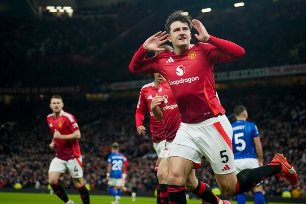 Manchester United's Harry Maguire celebrates after scoring his side's third goal during the English Premier League soccer match between Manchester United and Ipswich Town at the Old Trafford stadium in Manchester, England, Wednesday, Feb. 26, 2025. (AP Photo/Dave Thompson)