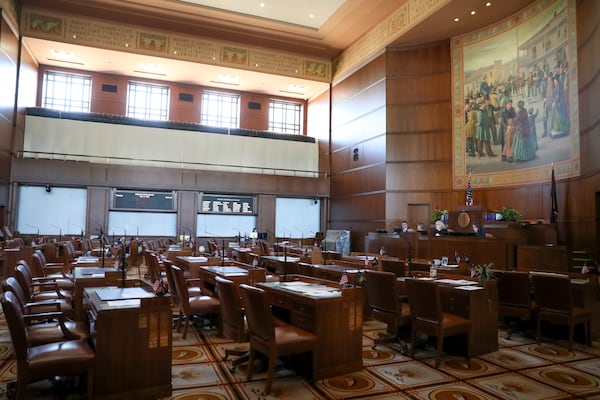 FILE - A view of the almost empty Senate chambers prior to a legislative session at the Oregon State Capitol in Salem, Ore., May 11, 2023. Republicans and an Independent senator in the Oregon Senate stretched their walkout to 10 days, triggering a new constitutional provision that prohibits lawmakers with 10 or more unexcused absences from being reelected. (AP Photo/Amanda Loman, File)