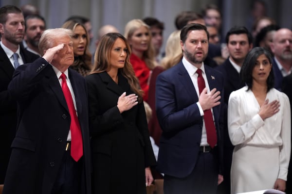 President Donald Trump, from left, salutes alongside first lady Melania Trump, Vice President JD Vance and his wife Usha Vance during the national prayer service at the Washington National Cathedral, Tuesday, Jan. 21, 2025, in Washington. (AP Photo/Evan Vucci)