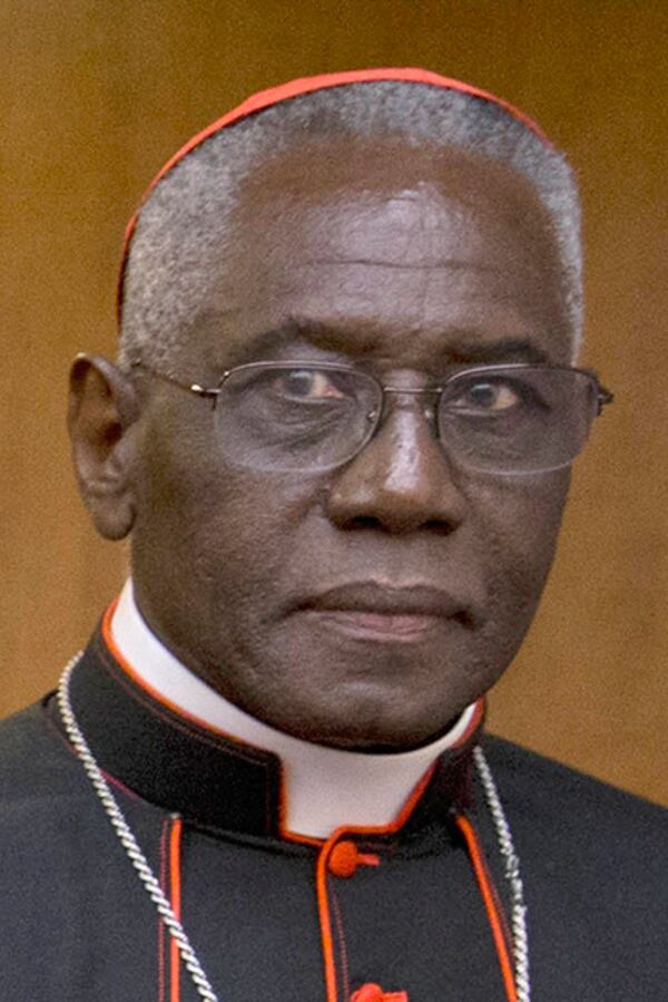 FILE - Cardinal Robert Sarah, prefect of the Congregation for Divine Worship and the Discipline of the Sacraments, arrives in Rome, Oct. 14, 2015. (AP Photo/Andrew Medichini, File)