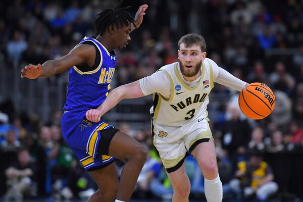 Purdue guard Braden Smith (3) drives to the basket against McNeese State guard T'Johnn Brown, left, during the second half in the second round of the NCAA college basketball tournament, Saturday, March 22, 2025, in Providence, R.I. (AP Photo/Steven Senne)