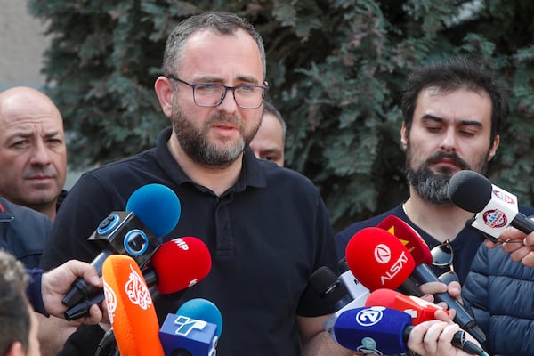 Macedonian Interior Minister Pance Toskovski speaks to media after a massive fire in the town of Kocani, North Macedonia, Sunday, March 16, 2025. (AP Photo/Boris Grdanoski)