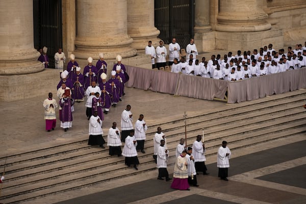 Cardinal Michael Czerny, left, delegate of Pope Francis who is being treated for pneumonia at Rome's Agostino Gemelli Polyclinic, arrives to celebrate a mass for the members of the world of volunteers in St. Peter's Square at The Vatican, Sunday, March 9, 2025. (AP Photo/Francisco Seco)