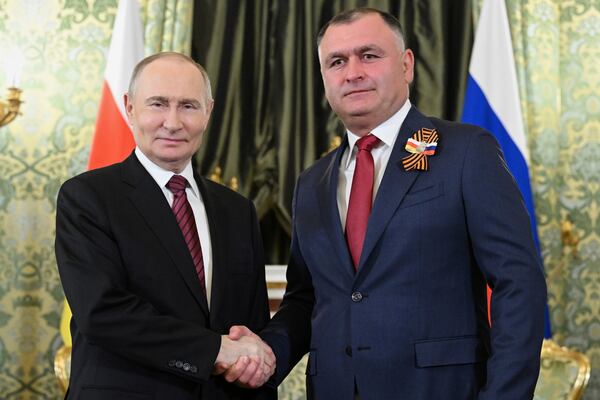 Russian President Vladimir Putin, left, and South Ossetian President Alan Gagloyev pose for a photo during their meeting in the Grand Palace at the Kremlin in Moscow, Russia, on Saturday, May 10, 2025, during celebrations of the 80th anniversary of the Soviet Union's victory over Nazi Germany during the World War II. (Sergei Bobylev/RIA Novosti via AP)