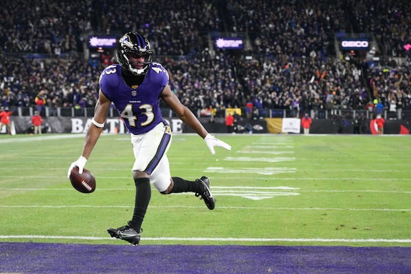 Baltimore Ravens running back Justice Hill scores on a pass from quarterback Lamar Jackson during the first half of an NFL wild-card playoff football game against the Pittsburgh Steelers, Saturday, Jan. 11, 2025, in Baltimore. (AP Photo/Nick Wass)