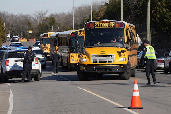 School buses arrive at a unification site following a shooting at the Antioch High School in Nashville, Tenn., Wednesday, Jan. 22, 2025. (AP Photo/George Walker IV)