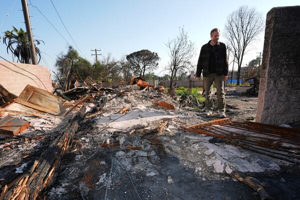 Tim Vordtriede looks at the remains of his property, which was destroyed the Eaton Fire in Altadena, Calif., on Tuesday, April 22, 2025. (AP Photo/Damian Dovarganes)