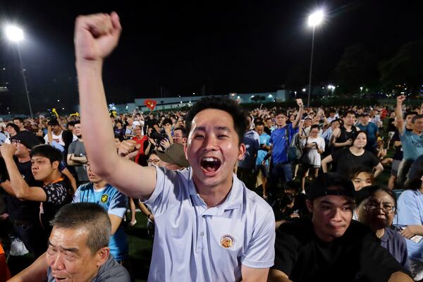 Workers' Party (WP) supporters react at an assembly centre during the general election, in Singapore, Saturday, May 3, 2025. (AP Photo/Suhaimi Abdullah)