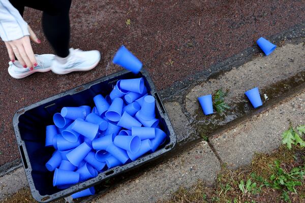 A runner discards a reusable silicone cup by Hiccup during the PNC Women Run the Cities race on Saturday, May 17, 2025, in Minneapolis. (AP Photo/Ellen Schmidt)