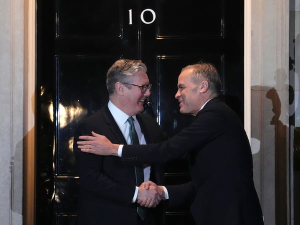 Canada Prime Minister Mark Carney is greeted by British Prime Minister Keir Starmer as he arrives in London on Monday, March 17, 2025. (Sean Kilpatrick/The Canadian Press via AP)