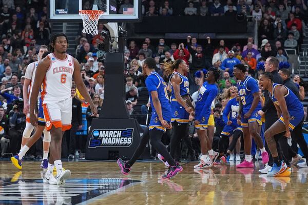 Clemson forward Myles Foster (6) walks back to the bench as McNeese State players celebrate a lead during the first half in the first round of the NCAA college basketball tournament, Thursday, March 20, 2025, in Providence, R.I. (AP Photo/Charles Krupa)