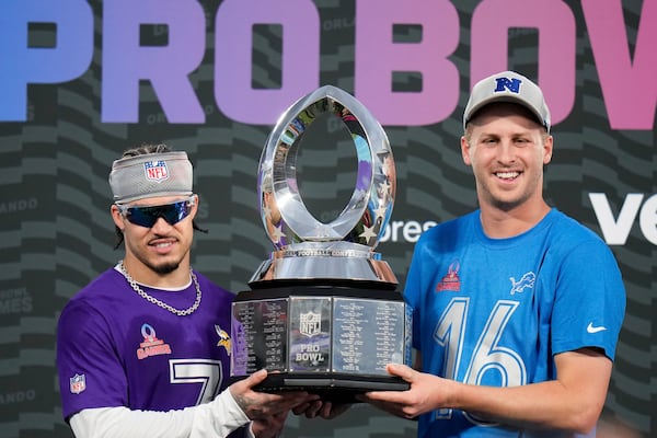 NFC cornerback Byron Murphy, left, of the Minnesota Vikings, and quarterback Jared Goff, right, of the Detroit Lions, hold the 2025 Pro Bowl trophy after being named defensive and offensive MVPs, respectively, for the flag football event at the NFL Pro Bowl, Sunday, Feb. 2, 2025, in Orlando. (AP Photo/Chris O'Meara)