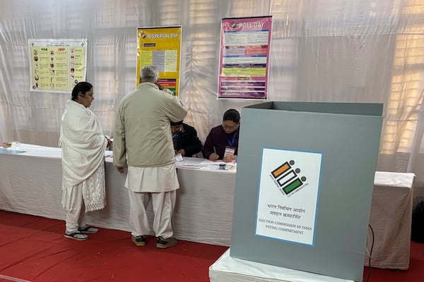 People cast their votes for the capital’s state legislature election at a polling booth in New Delhi, India, Wednesday, Feb. 5, 2025. (AP Photo/Shonal Ganguly)