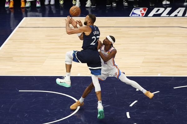 Oklahoma City Thunder guard Shai Gilgeous-Alexander (2) defends against Minnesota Timberwolves center Rudy Gobert (27) during the first half of Game 3 of the Western Conference finals of the NBA basketball playoffs, Saturday, May 24, 2025, in Minneapolis. (AP Photo/Matt Krohn)