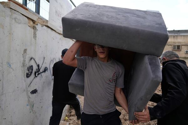 Residents of the now evacuated refugee camp of Tulkarem return to collect belongings before the destruction of their homes as Israeli forces prepare to carry out the demolition of 116 homes across the two refugee camps of the Israeli occupied West Bank city of Tulkarem, Friday, May 2, 2025. (AP Photo/Nasser Nasser)