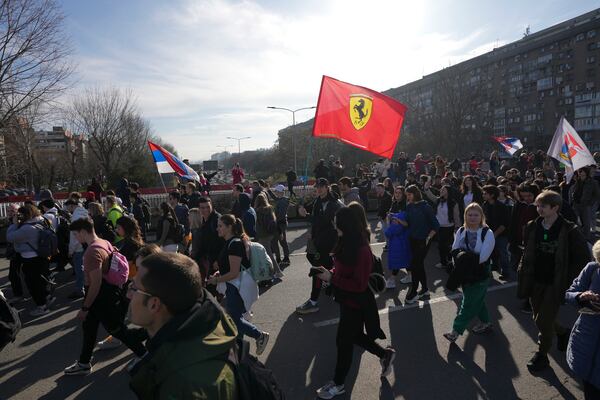 Students walk on the street towards the northern city of Novi Sad, where they will participate in a 24 hour block of three bridges to protest the deaths of 15 people killed in the November collapse of a train station canopy, in Belgrade, Serbia, Thursday, Jan. 30, 2025. (AP Photo/Darko Vojinovic)