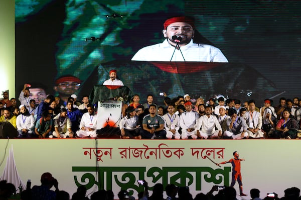 Nahid Islam, who was named as the head of the newly formed Jatiya Nagarik Party, or National Citizen Party, is projected on a digital screen as he speaks to supporters from a podium, in Dhaka, Bangladesh, Friday, Feb. 28, 2025. (AP Photo/Mahmud Hossain Opu)