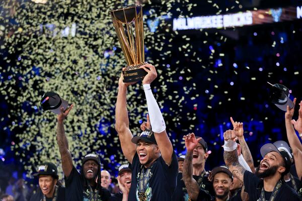 Milwaukee Bucks forward Giannis Antetokounmpo (34) yells while lifting up the NBA Cup after his team's victory in the championship game of the NBA Cup basketball tournament against the Oklahoma City Thunder Tuesday, Dec. 17, 2024, in Las Vegas. (AP Photo/Ian Maule)