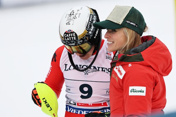 Switzerland's Wendy Holdener, left, celebrates with Switzerland's Lara Gut Behrami at the finish area of a slalom run of a women's team combined event, at the Alpine Ski World Championships, in Saalbach-Hinterglemm, Austria, Tuesday, Feb. 11, 2025. (AP Photo/Marco Trovati)