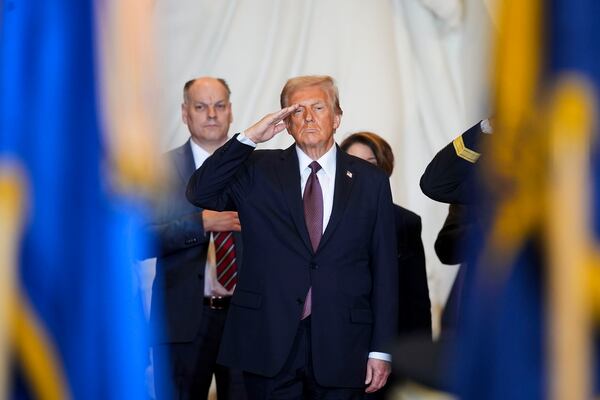 President Donald Trump salutes while on stage in Emancipation Hall at the 60th Presidential Inauguration, Monday, Jan. 20, 2025, at the U.S. Capitol in Washington. (Al Drago/Pool Photo via AP)