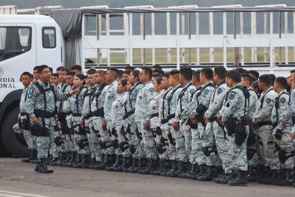 Mexican National Guards line up before boarding an aircraft at the International Airport in Merida, Mexico, Tuesday, Feb. 4, 2025, to fly to Ciudad Juarez and reinforce the country's northern border with the United States. (AP Photo/Martin Zetina)