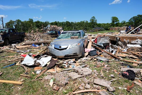 Debris covers the ground and damaged vehicles after a severe storm passed the area on Saturday, May 17, 2025, in London, Ky. (AP Photo/Carolyn Kaster)
