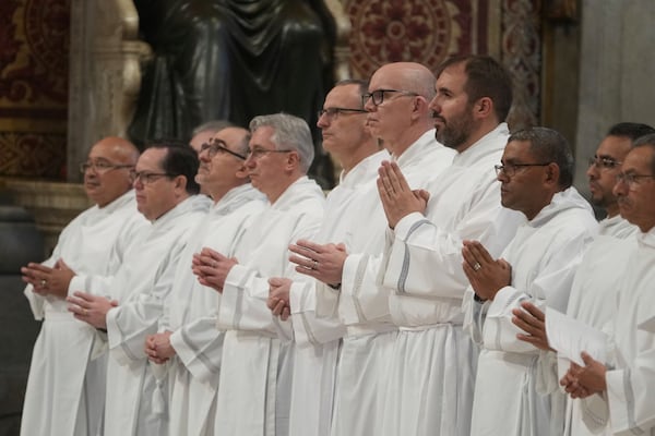 Deacons take part in a mass for their jubilee in St. Peter's Basilica at The Vatican that was supposed to be presided over by Pope Francis who was admitted over a week ago at Rome's Agostino Gemelli Polyclinic and is in critical conditions. (AP Photo/Alessandra Tarantino)